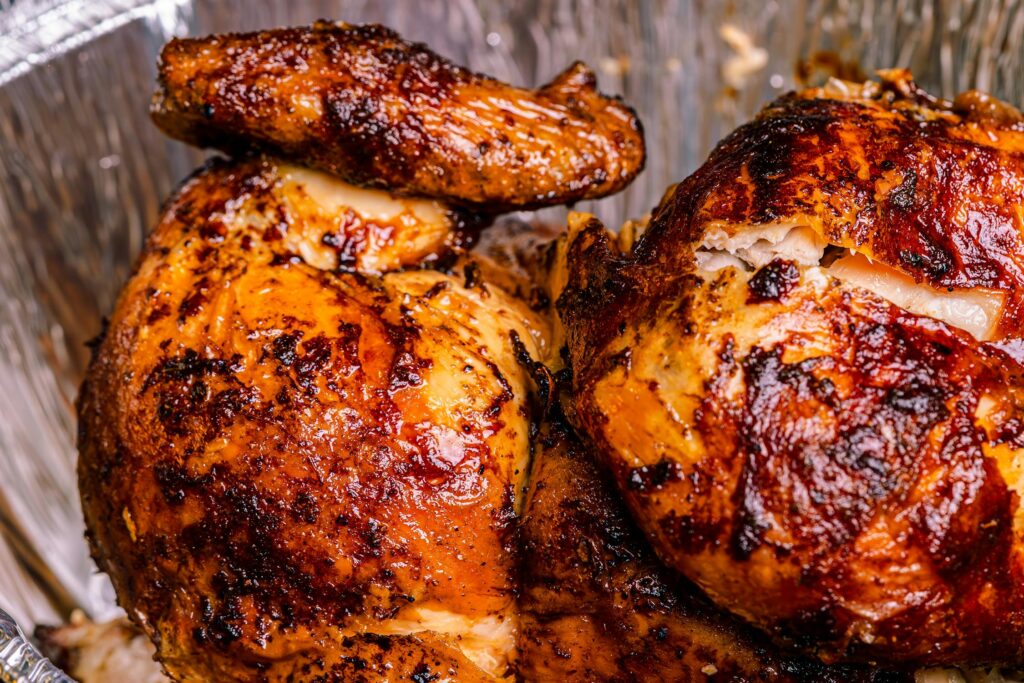 Sliced Pollo a la Brasa served with fries, salad, and sauces