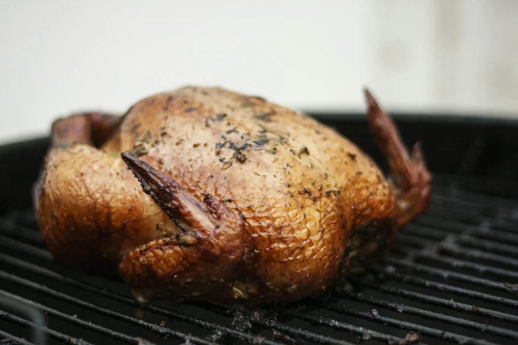 Pollo a la Brasa roasting on a charcoal rotisserie