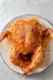 Marinating Peruvian rotisserie chicken with spices and lime