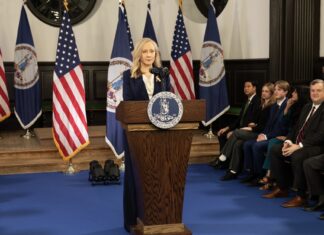 Spanberger Orders Statewide Plan for AI-Related Cyberattacks Governor Abigail Spanberger stands at a podium bearing the Virginia state seal, with U.S. and Virginia flags behind her and officials seated nearby. (Photo: @GovernorVA/X)
