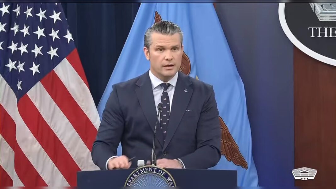 Defense Secretary Pete Hegseth speaking at a Pentagon press briefing podium