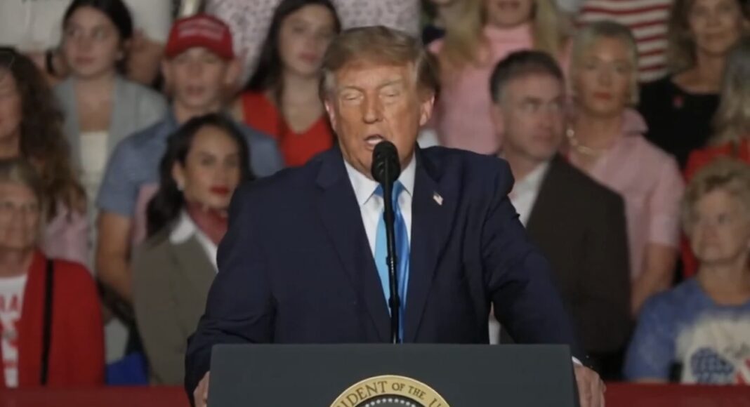 President Donald Trump speaks at a podium bearing the presidential seal