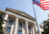 DOJ Uncovers Nearly $42M in SNAP Fraud in Nationwide Surge The U.S. Department of Justice building in Washington, D.C., with an American flag flying in front. (U.S. Justice Department)