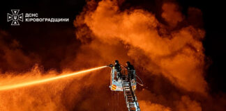 Firefighters on an aerial ladder platform spray water into heavy smoke at night after Russian attacks on Ukraine. (Photo: Zelenskyy via X)