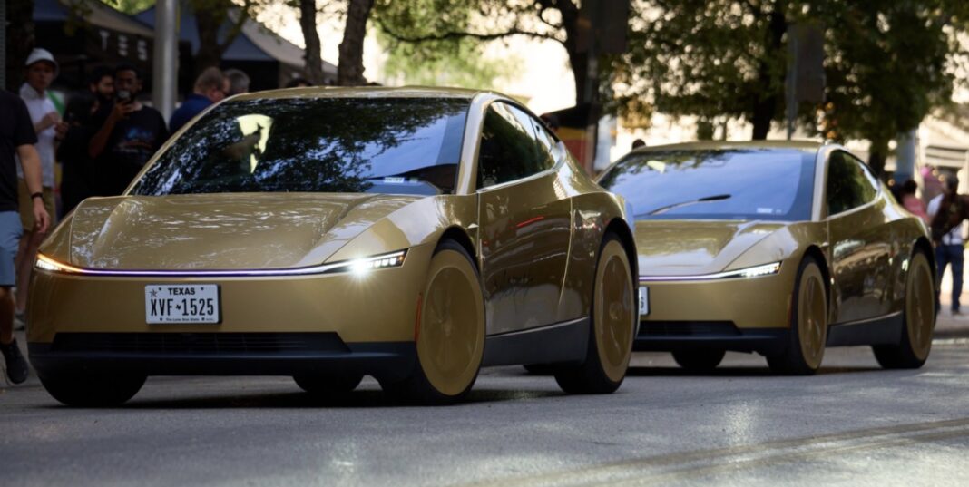 Two gold Tesla Cybercabs drive down a tree-lined street while people on the sidewalk take photos.