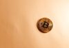Brooklyn DA Dismantles Crypto Scam Targeting Russian Speakers A gold Bitcoin coin on a neutral surface representing the Brooklyn DA crypto scam investigation