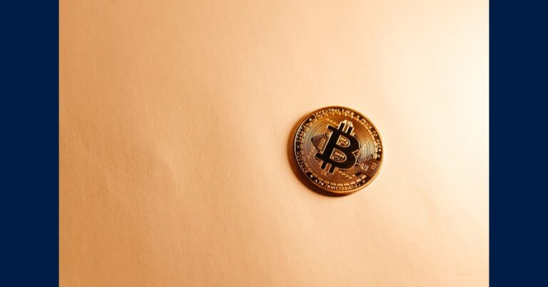 A gold Bitcoin coin on a neutral surface representing the Brooklyn DA crypto scam investigation