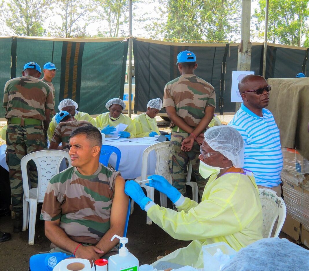 Health worker vaccinating a UN peacekeeper against Ebola in DR Congo (file photo)