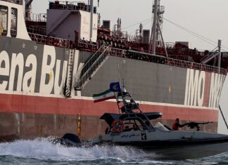 Iran Guards Say Three Tankers Hit Mines in Hormuz IRGC speedboat beside the tanker Stena Impero in the Strait of Hormuz — Iran Guards tanker mines claim