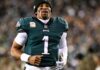 Hurts Expected to Miss Rest of Season With Blood Clots in Lungs Philadelphia Eagles quarterback Jalen Hurts in his green No. 1 Eagles jersey and a black beanie on the field, with a blurred crowd behind him.
