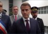 Macron Says Racist Terror Attack Leaves One Dead, Five Critical French President Emmanuel Macron stands with officials while delivering a statement in Trappes.