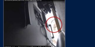 Surveillance still from the federal complaint showing Abdulrahman Alfozan, circled in red, looking behind a television in an OpenAI executive conference room on Oct. 5, 2026.