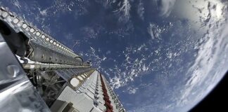A stack of Starlink satellites atop a Falcon 9 rocket above Earth.