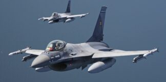 Two Romanian Air Force F-16 fighter jets in flight over the sea