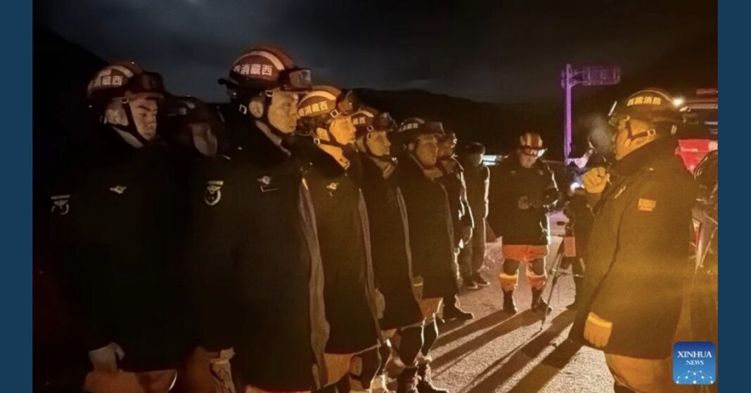 Firefighters with the Xizang fire and rescue service line up for a nighttime briefing during the earthquake response in Nagqu, Tibet.