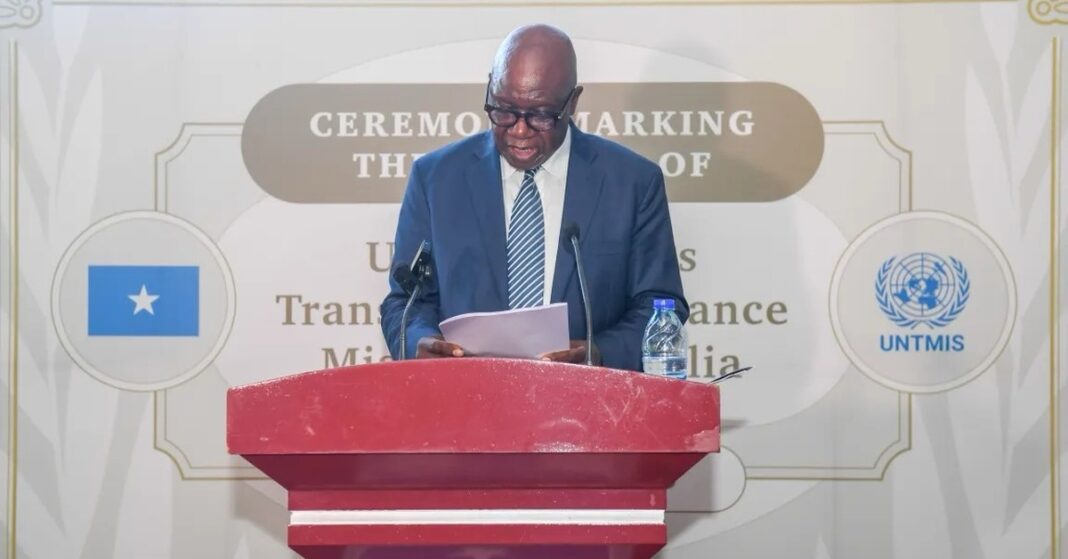 Raisedon Zenenga speaks at a podium during the UNTMIS closure ceremony in Mogadishu, Somalia.