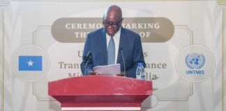 Raisedon Zenenga speaks at a podium during the UNTMIS closure ceremony in Mogadishu, Somalia.