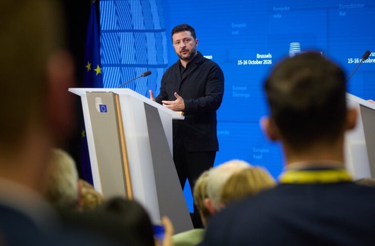 Zelenskyy Expects More Sanctions Relief, Seeks U.S. Talks Ukrainian President Volodymyr Zelenskyy speaking at a podium in Brussels during the European Council meeting, 15-16 October 2026