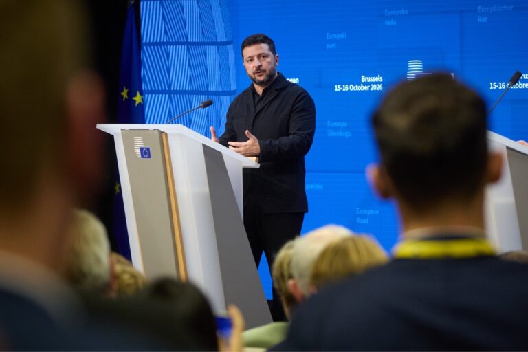 Ukrainian President Volodymyr Zelenskyy speaking at a podium in Brussels during the European Council meeting, 15-16 October 2026