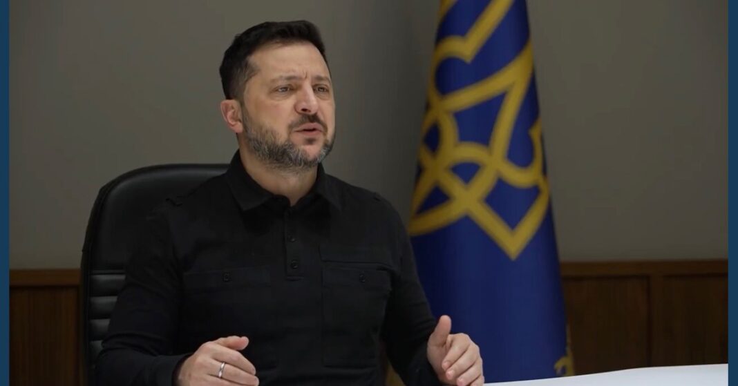 Zelenskyy trilateral talks: Ukrainian President Volodymyr Zelenskyy speaks beside a blue and gold flag during a Hudson Institute address